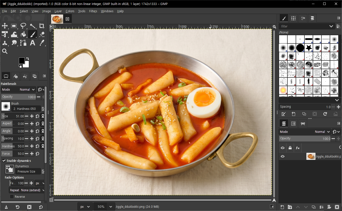 GIMP with a food photo open — tool palette on the left, layers and brushes on the right
