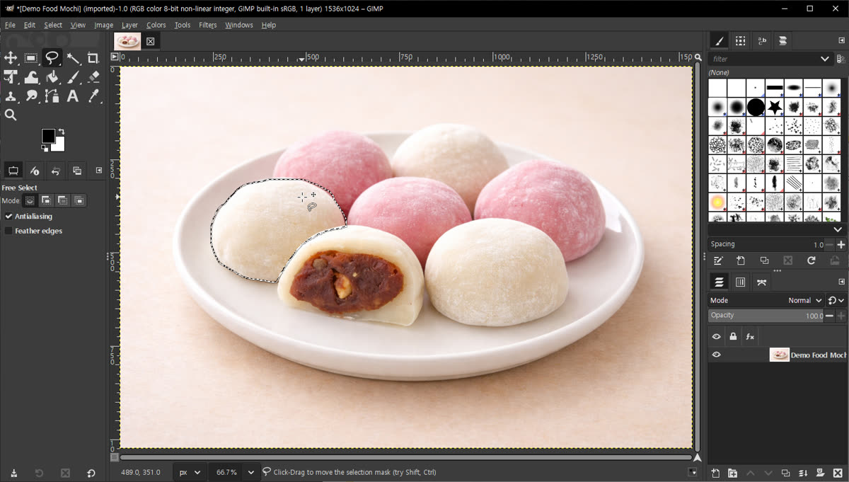 A screenshot of GIMP with an active free-select lasso outline drawn around two mochi on a plate